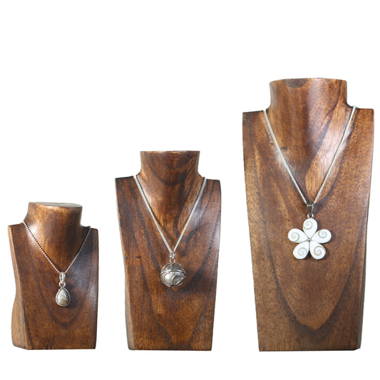 three wooden vases with necklaces on them